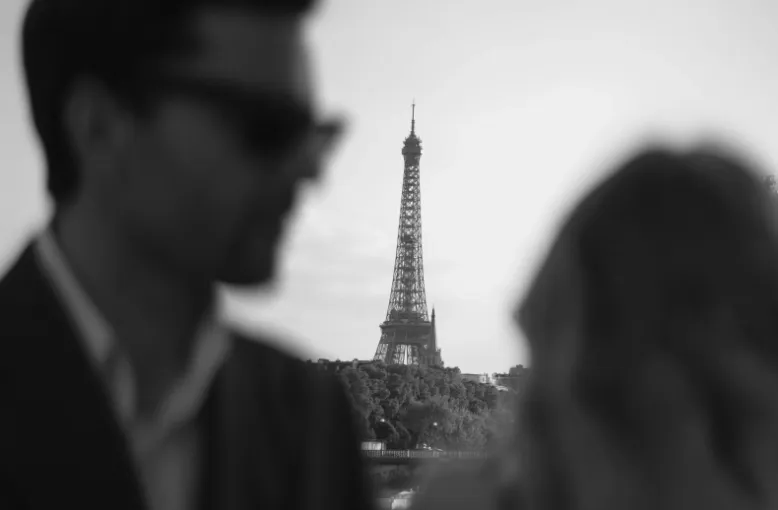 Couple in soft focus with the Eiffel Tower sharp between them