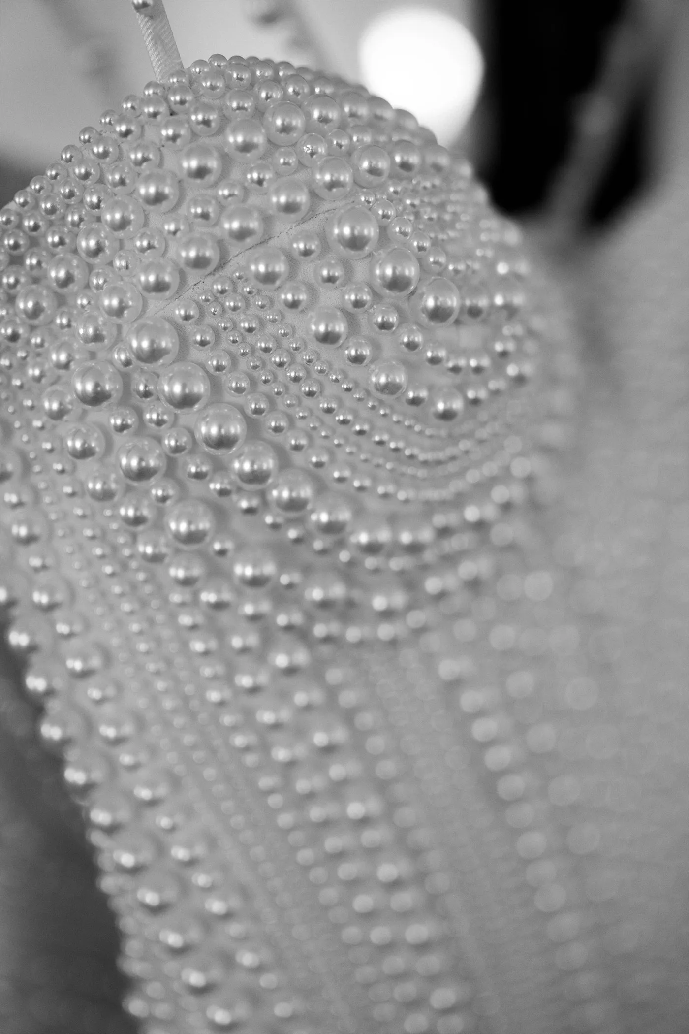 Close-up of a wedding dress bodice covered in graduated pearl beading